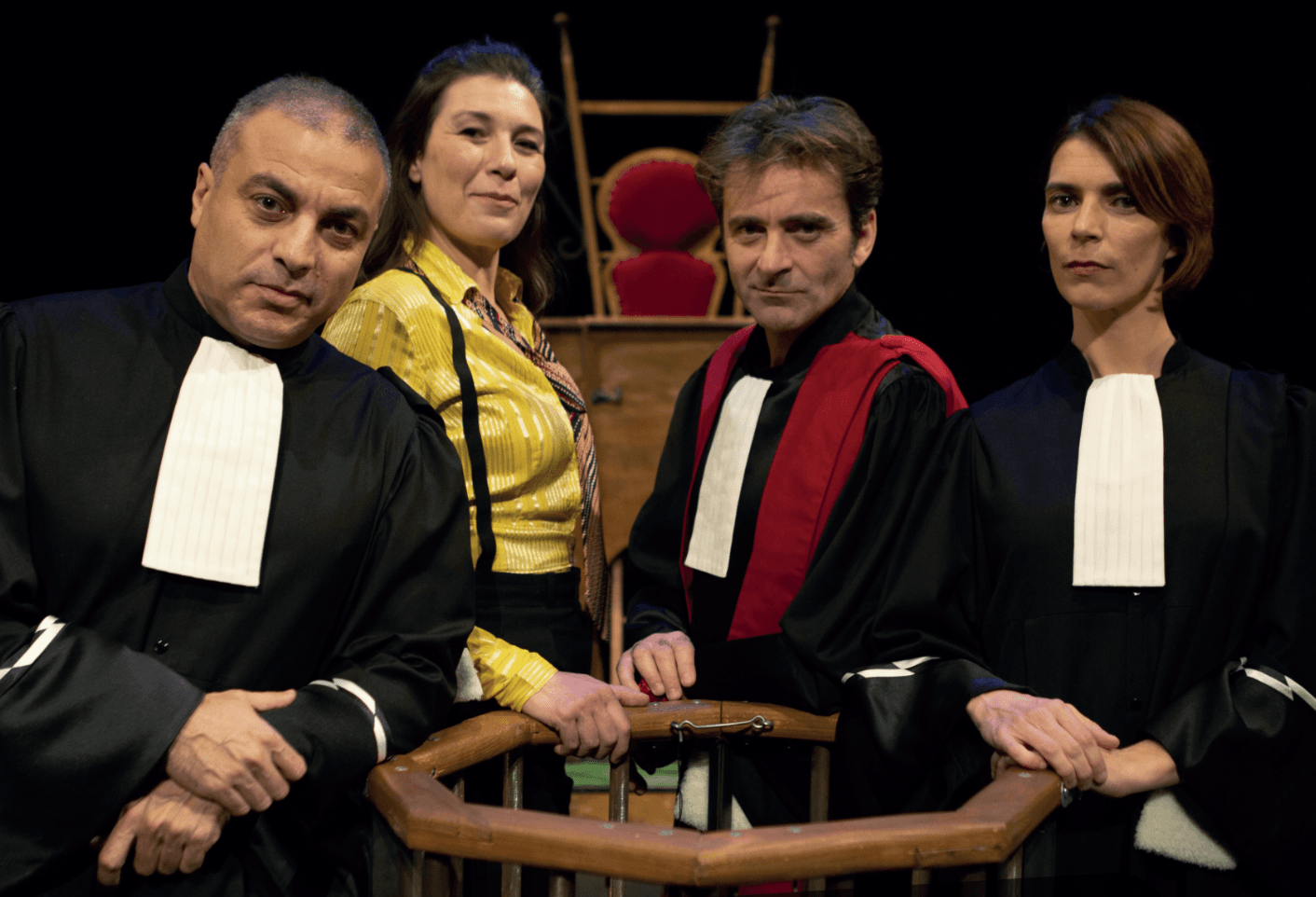 Four people dressed in court robes looking into the camera