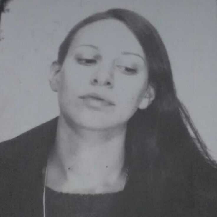 Genny Petrottas picture is from photo booth and it is black and white. Genny looks to the left bottom corner and wears the hair on one side.