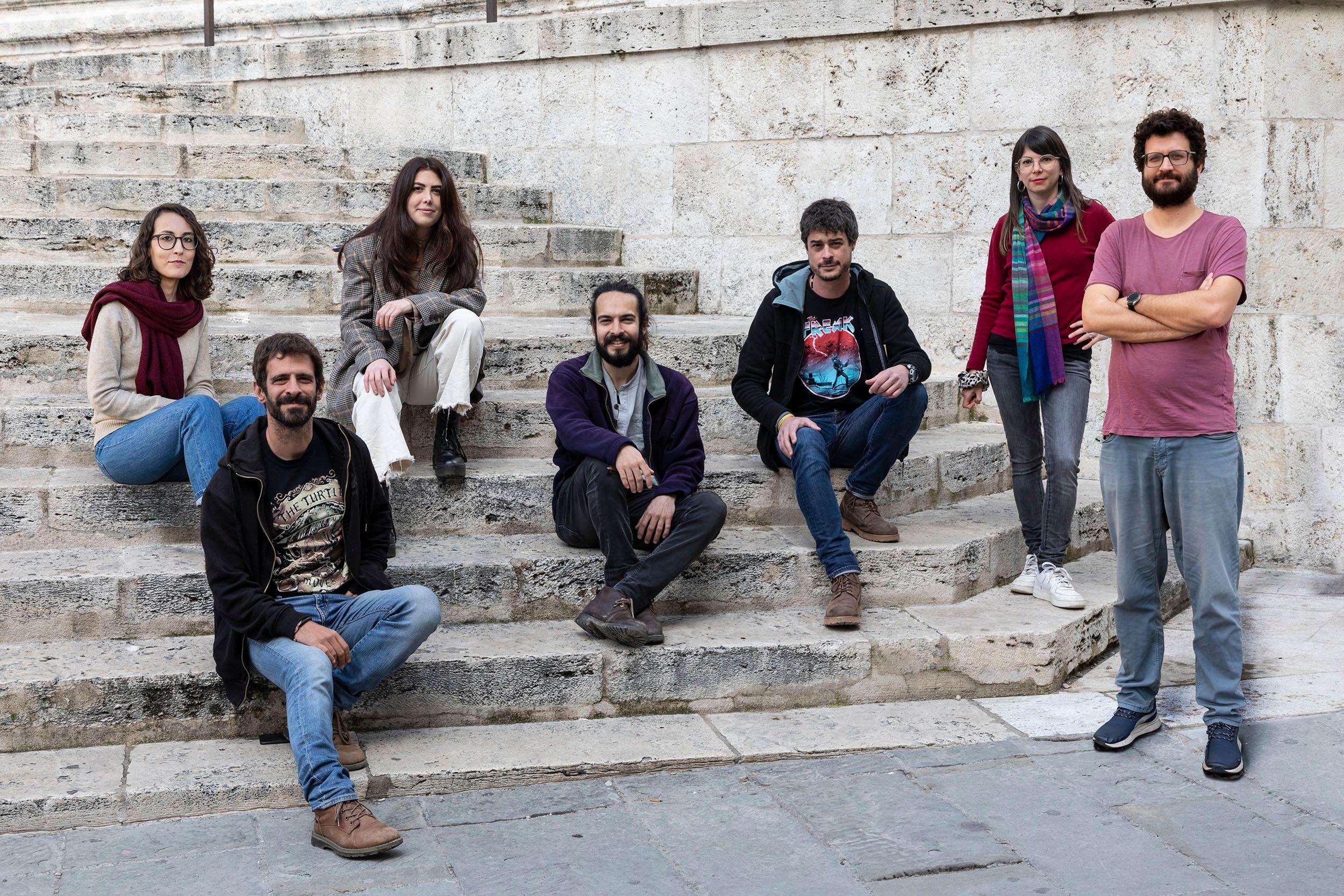 The team of IRPI is sitting on stairs, some are standing