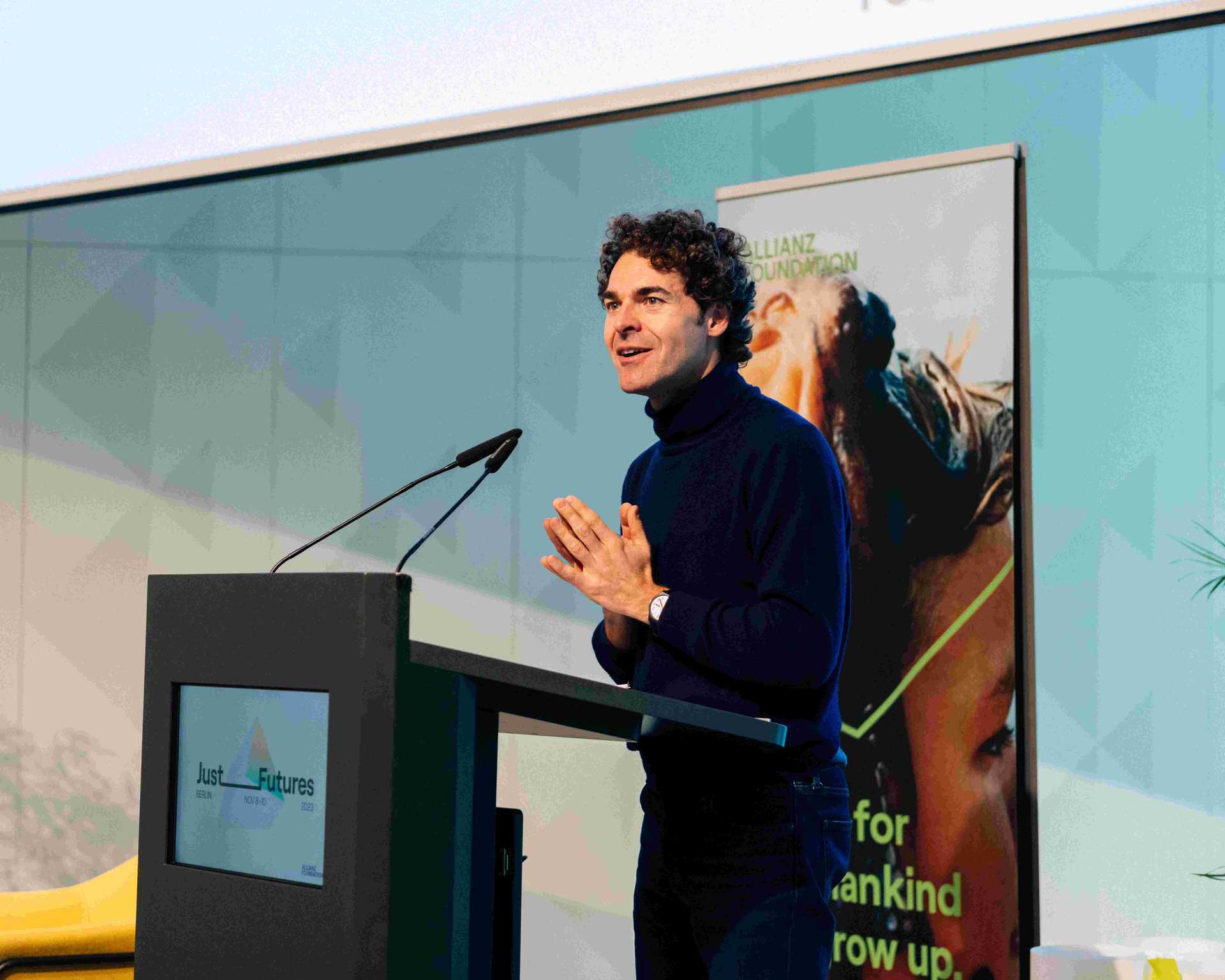 Alberto Alemanno is speaking to the audience on a stage