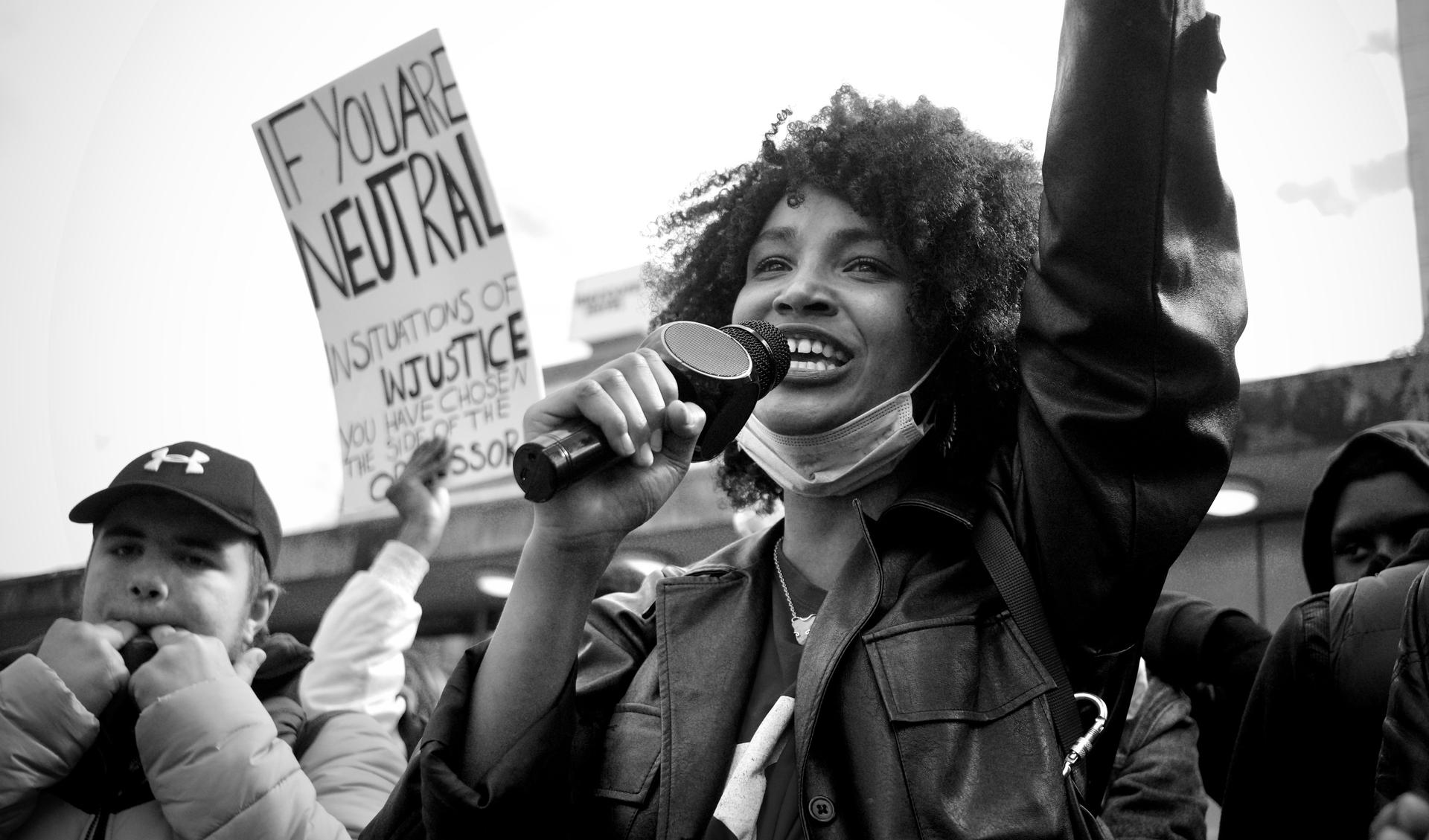 A person on a demonstration speaks into a micro