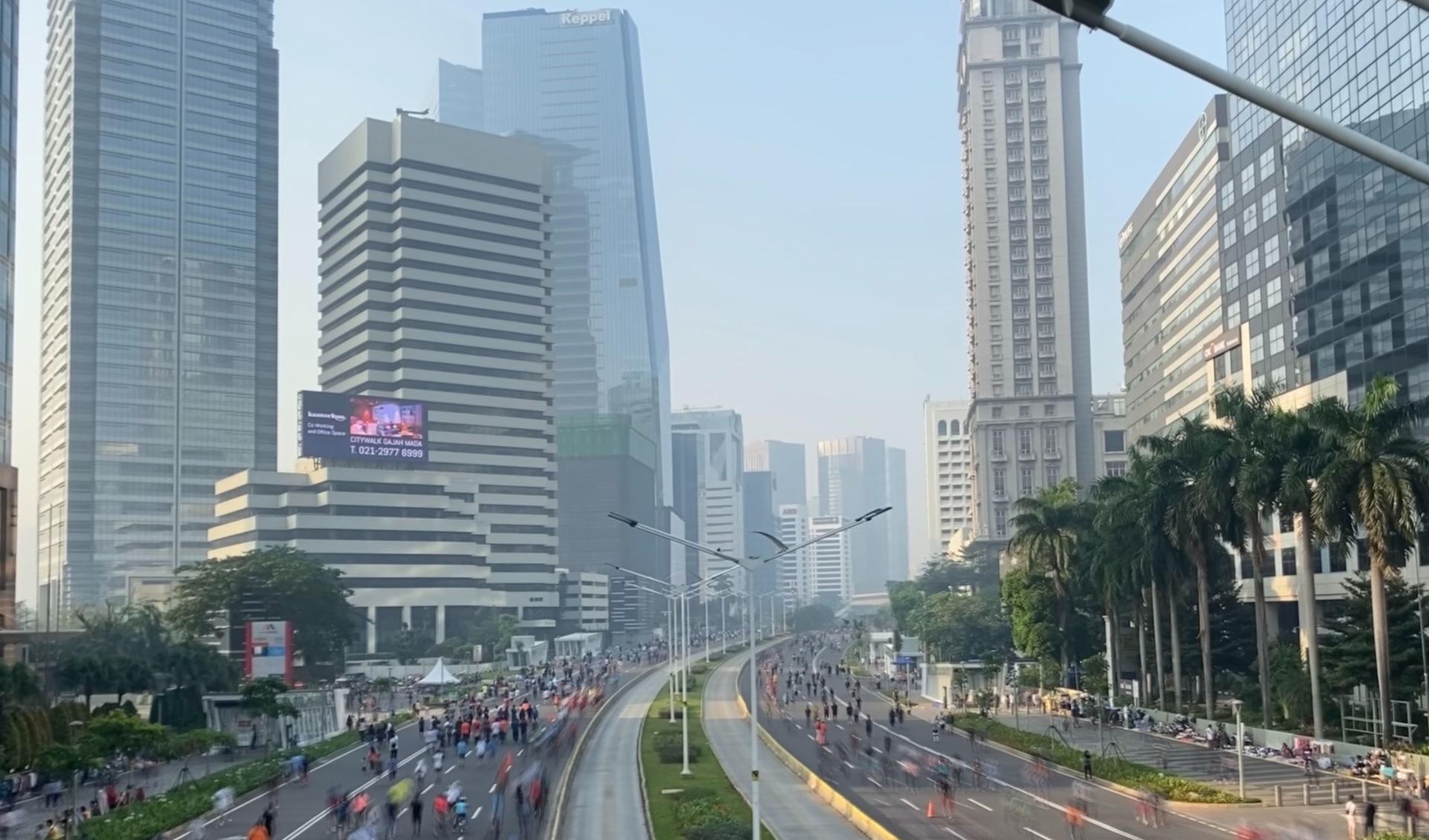 Big streets in Jakarta are free from cars. Many people and bicycles are on the streets