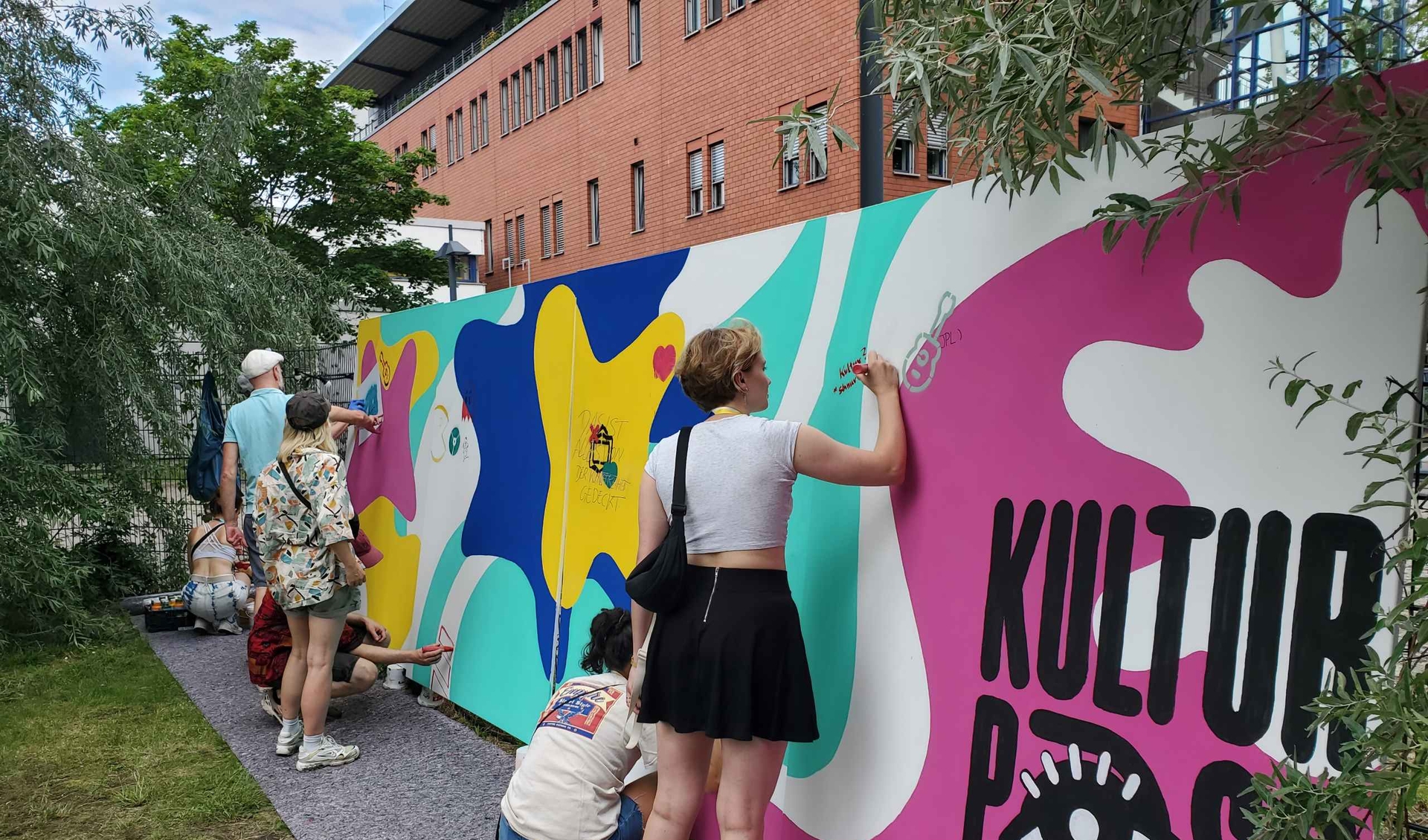People are painting a wall