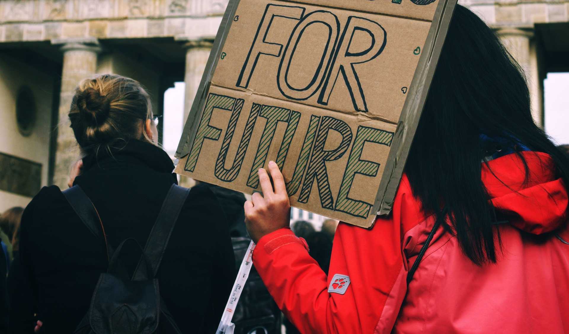 A person is hoding a selmade protest slogan on which "For Future" is written.
