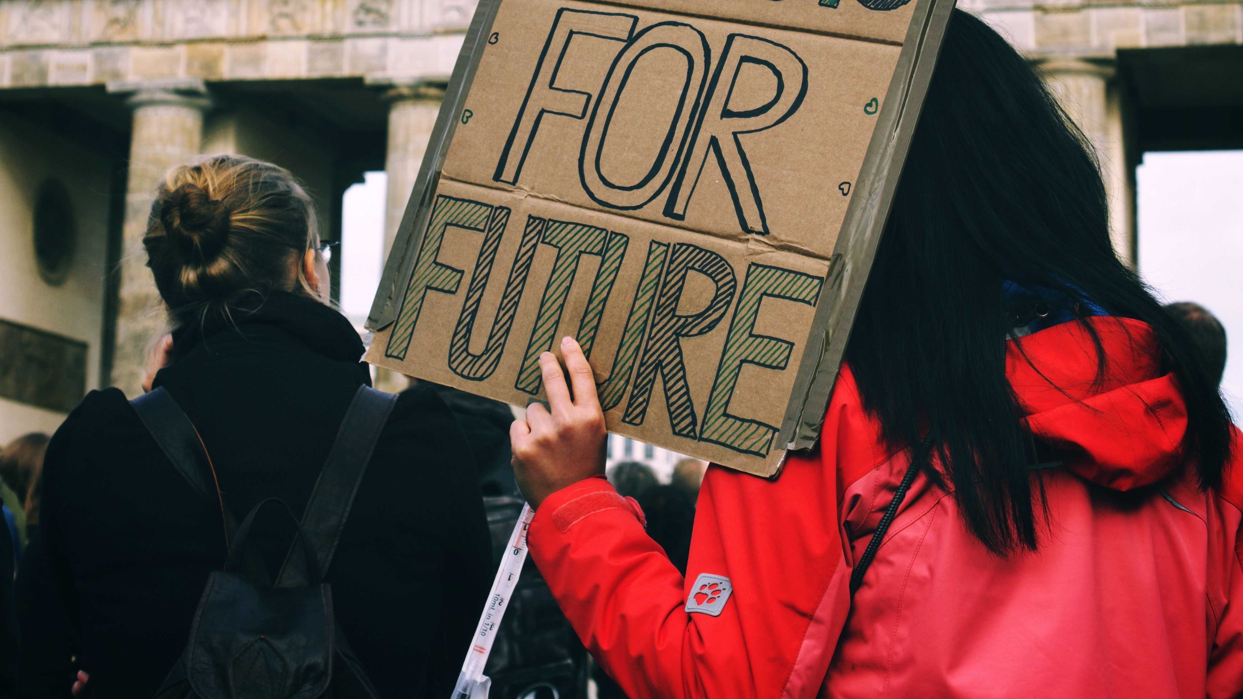 A person is hoding a selmade protest slogan on which "For Future" is written.