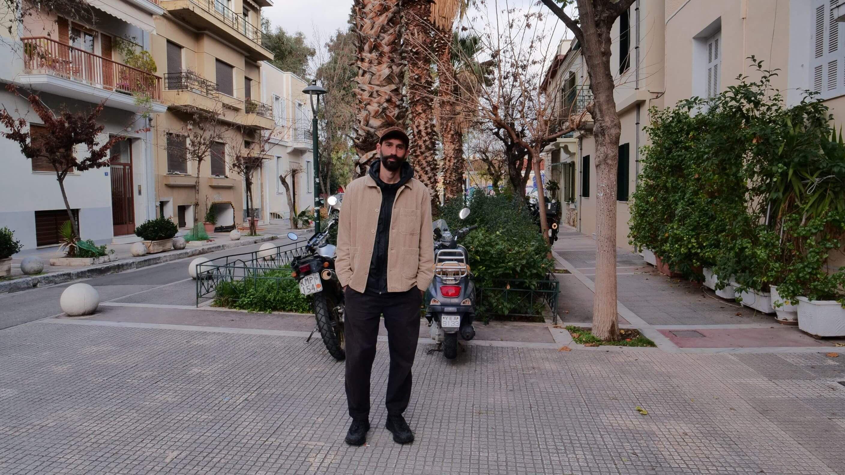 Stefanos Levidis stands in a street