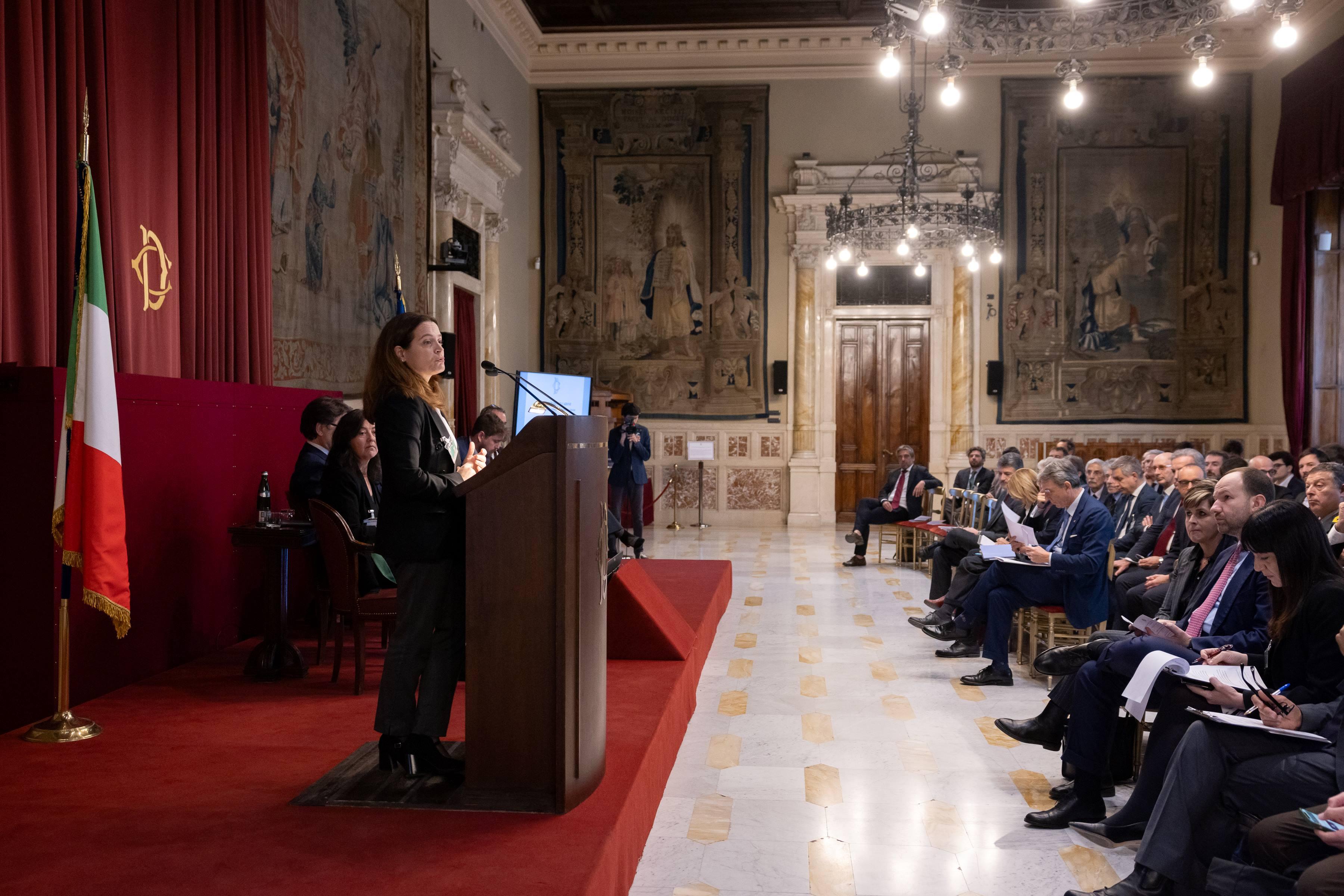 Chiara di Mambro, team member of ECCO during an event. She stands in front of the guests and talks to them