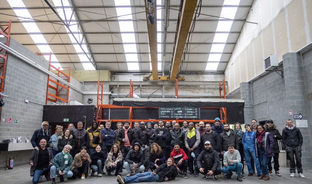 The team of Recyclart is standing in a workshop.