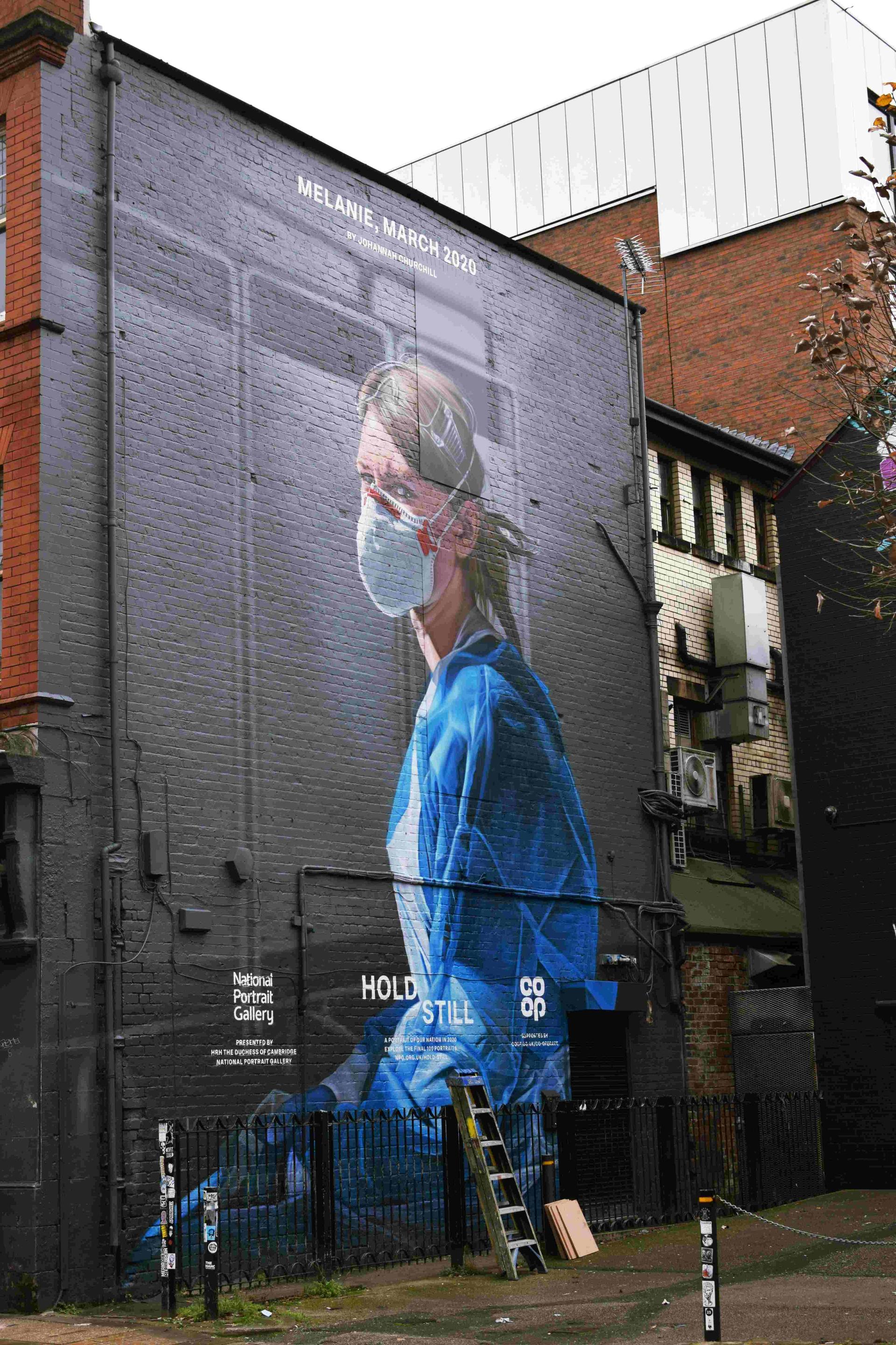 A mural of a NHS worker with a Covid-mask on a wall in UK