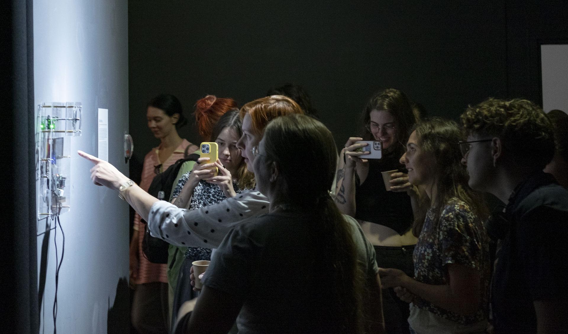 People are ineracting with a light installation during an exhibition