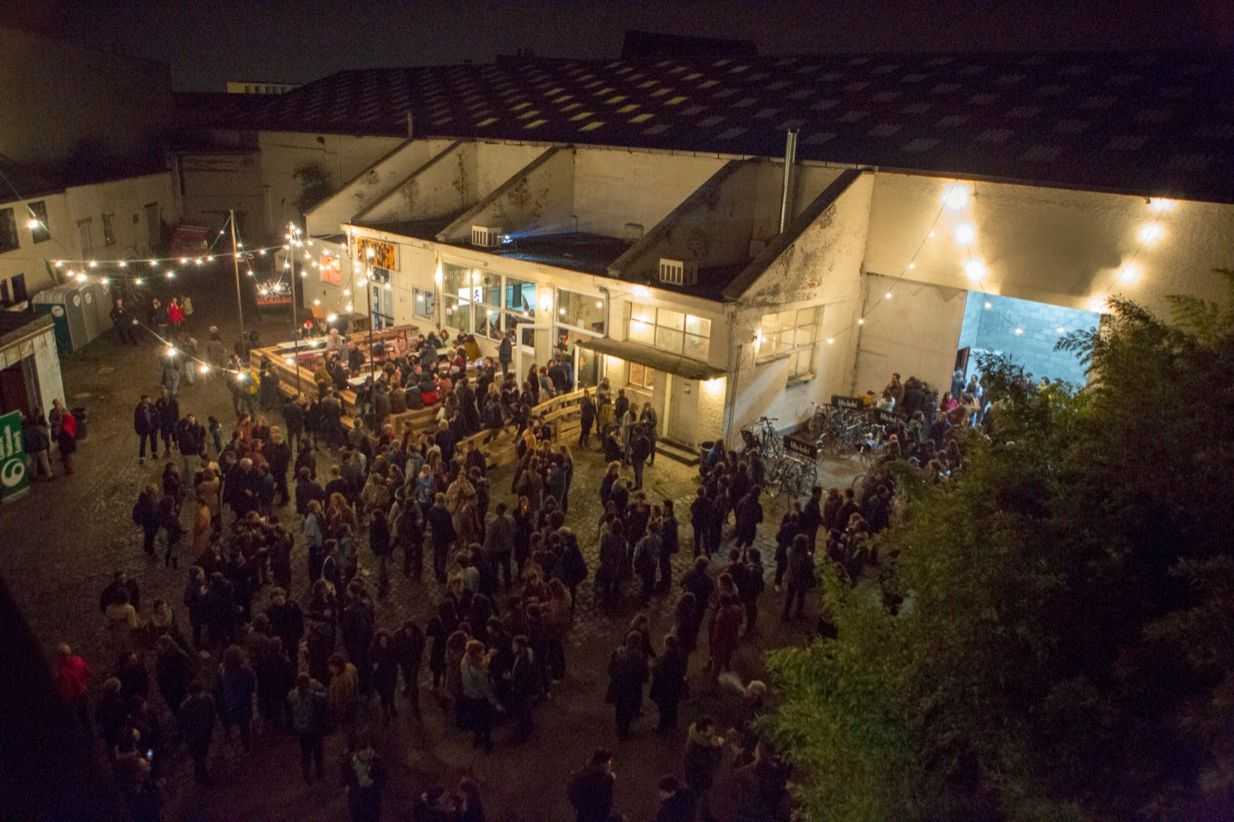The site of the Hub pictured from above with many people standing in the courtyard