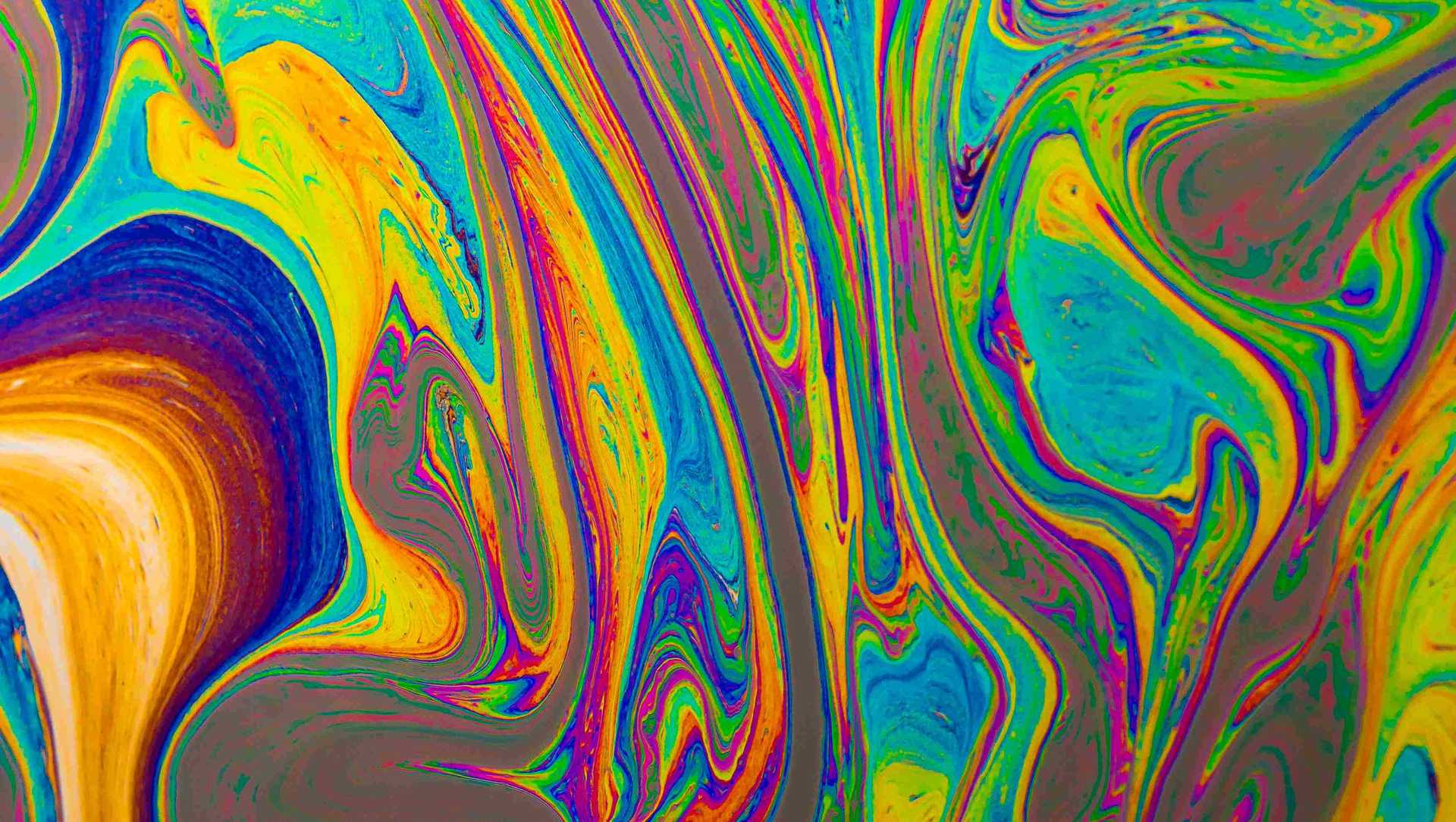 Oil on water is creating a colorful picture.